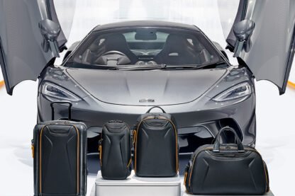 TUMI McLaren_Lifestyle_Aero International Expandable 4 Wheeled Carry-On in Black and Torque Sling in Black and Velocity Backpack in Black and Quantum Duffel in Black