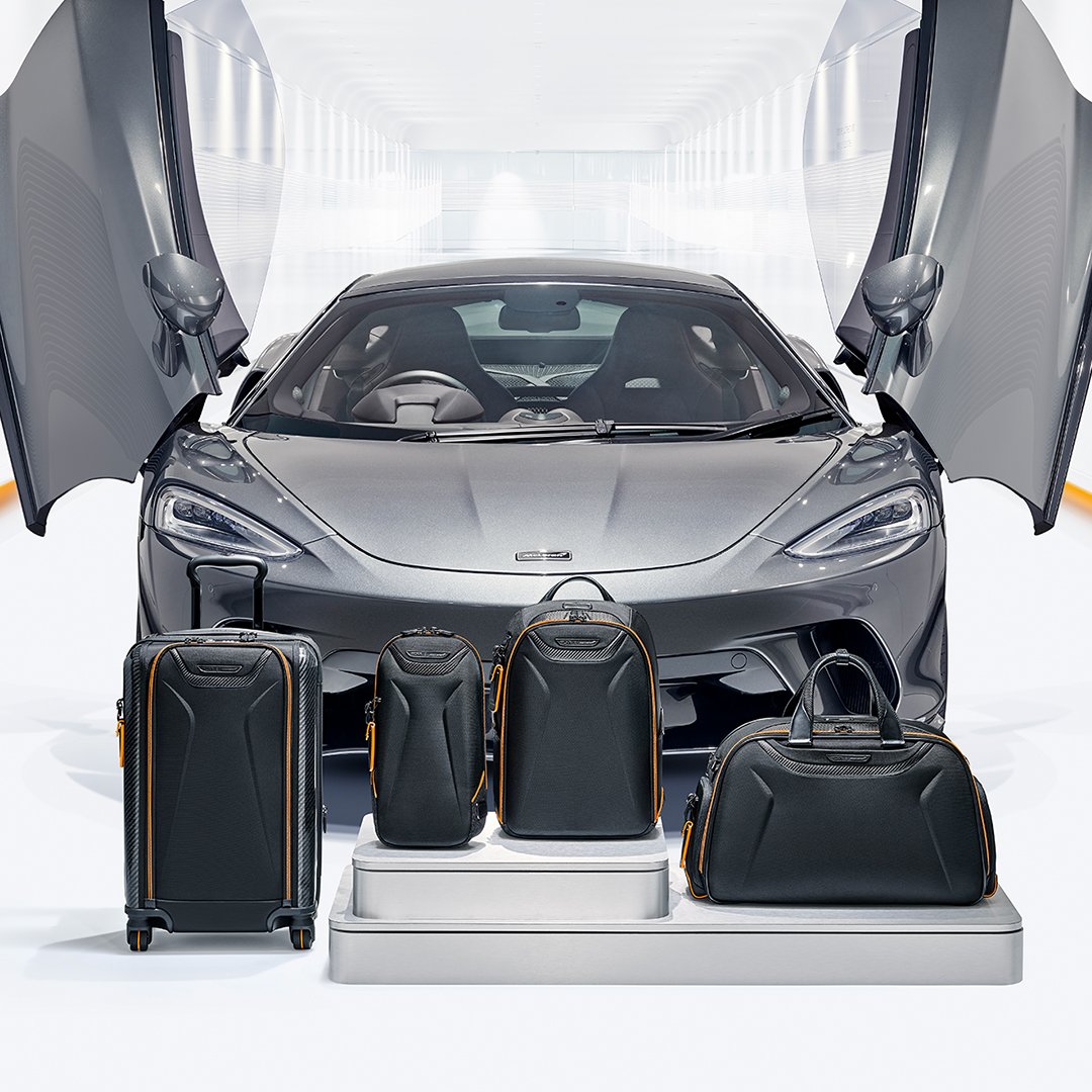 TUMI McLaren_Lifestyle_Aero International Expandable 4 Wheeled Carry-On in Black and Torque Sling in Black and Velocity Backpack in Black and Quantum Duffel in Black