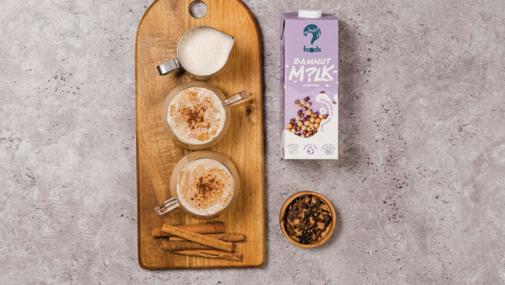 Two cups of chai latte with a glass of bamnut milk by WhatIF Foods.