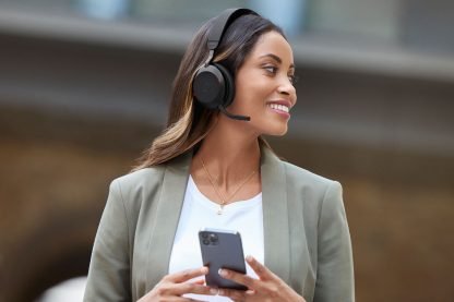 Jabra-Evolve2-75-Lifestyle-Female-Street-Walking-Phone-Medium