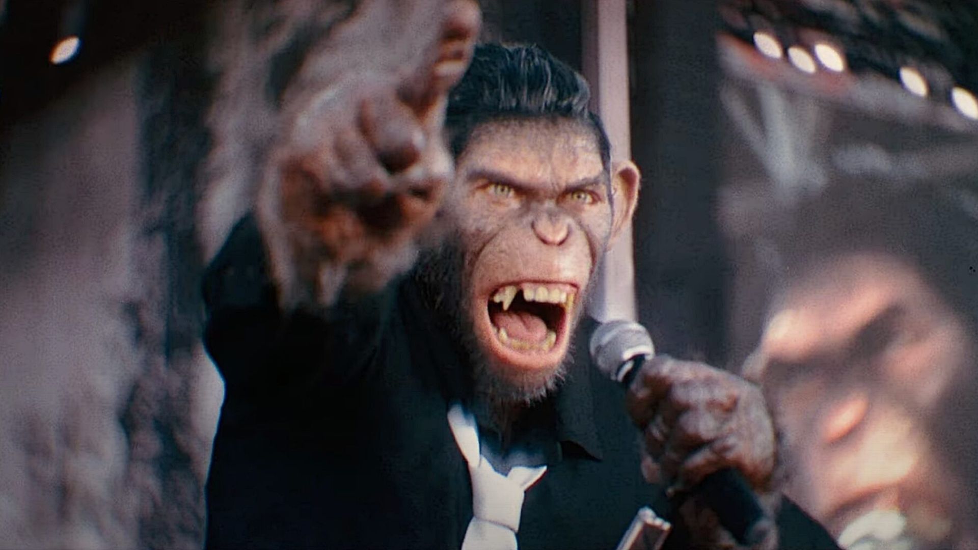 Robbie Williams as a monkey in Better Man shouts into a microphone.